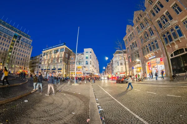 AMSTERDAM - APRIL 25, 2015: Tourists and locals in Dam Square at