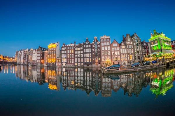 Beautiful night skyline of Amsterdam. City homes along canal