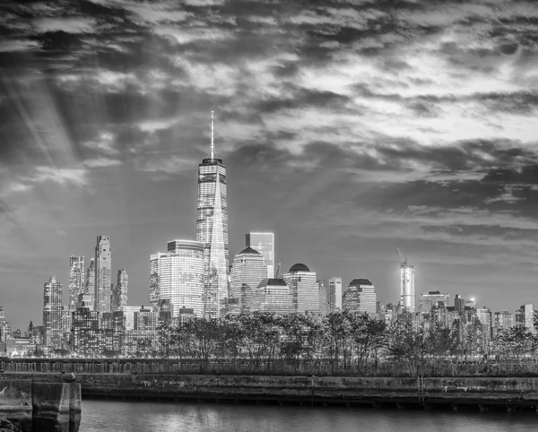 Black and white night skyline of Manhattan from Jersey City Pier