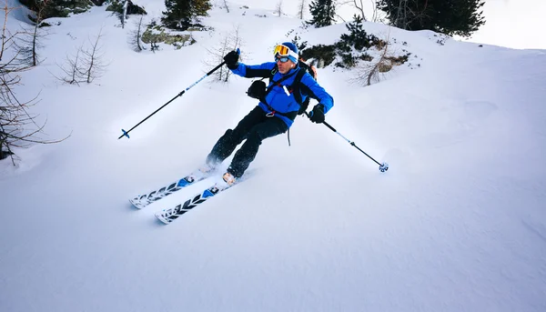Winter sport: man skiing in powder snow.
