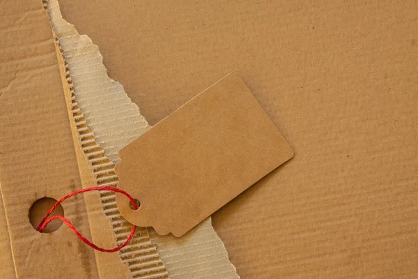 Background texture of corrugated cardboard and a tag