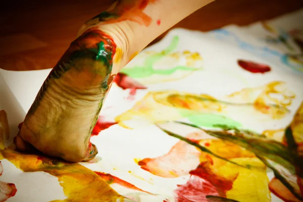 Child's foot smeared with paints