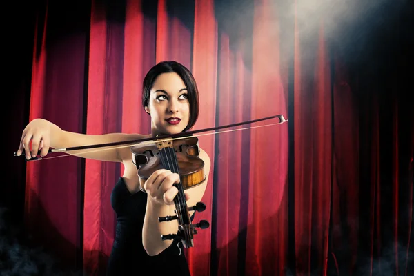 Elegant woman playing the violin