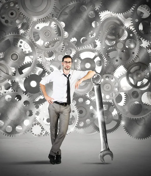 Businessman makes maintenance of gears