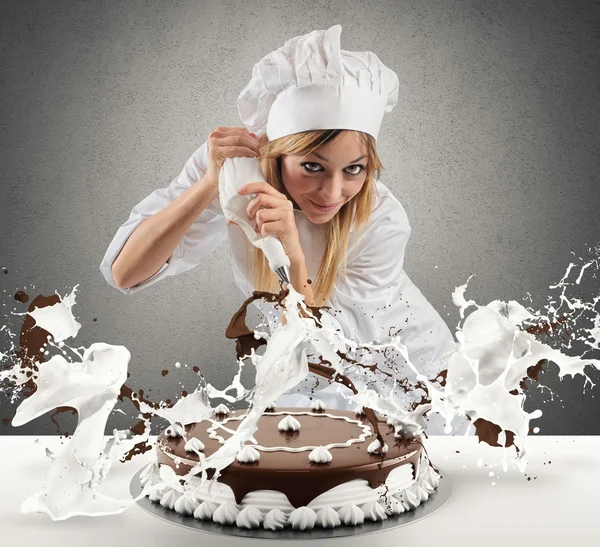 Pastry cook prepares a cake
