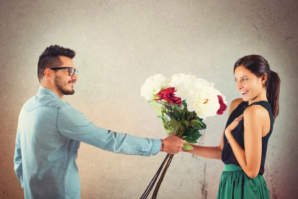 Boy gives flowers to girlfriend