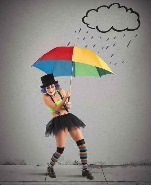 Woman clown with umbrella