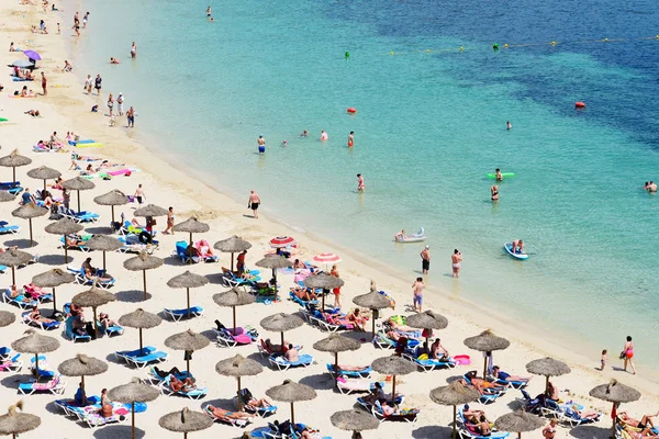 MALLORCA, SPAIN - MAY 29: The tourists enjoiying their vacation on the beach on May 29, 2015 in Mallorca, Spain. Up to 60 mln tourists is expected to visit Spain in year 2015.