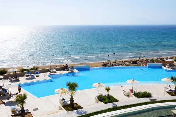 PATRONIKOLEIKA, GREECE - JUNE 10: The beach of luxury hotel and tourists enjoing their vacation on June 10, 2013 in Patronikoleika,  Greece. Up to 16 mln tourists is expected to visit Greece in year 2013.