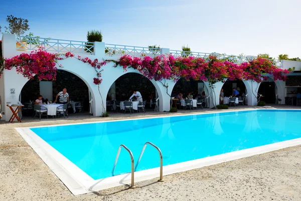 OIA, GREECE - MAY 19: The tourists enjoying their vacation at luxury hotel on May 19, 2014 in Oia, Greece. Up to 16 mln tourists is expected to visit Greece in year 2014.