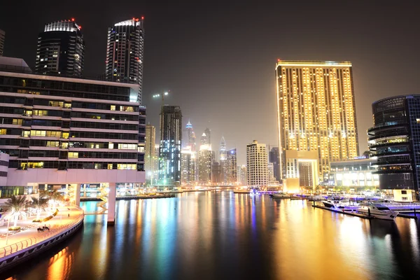DUBAI, UAE - SEPTEMBER 8: The night illumination of Dubai Marina on September 8, 2013 in Dubai, UAE. It is an artificial canal city, built along a two mile (3 km) stretch of Persian Gulf shoreline.