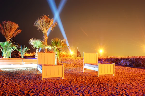 Beach of luxury hotel in night illumination on Palm Jumeirah man