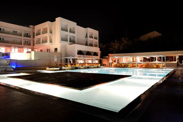 Swimming pool and bar in night illumination at the luxury hotel,