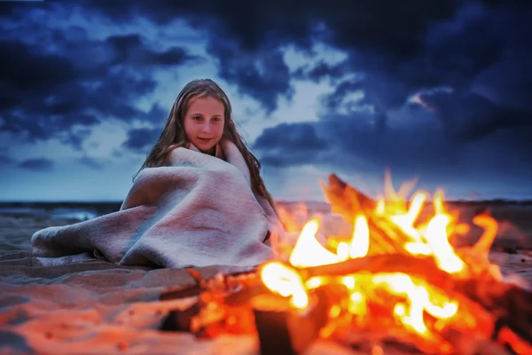 Girl near camping fire.
