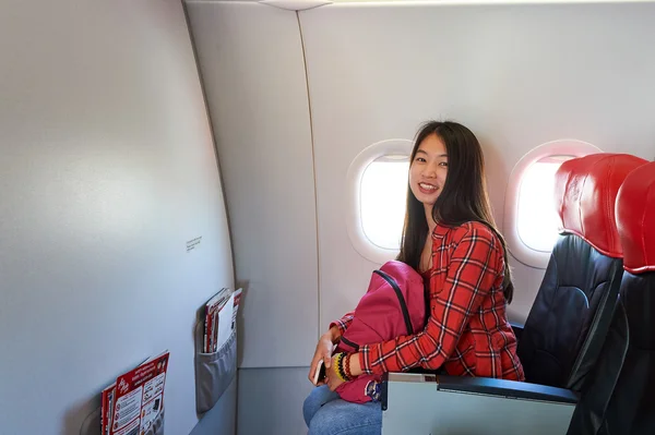 Woman sitting in chair inside plane