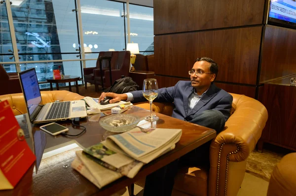 Man in Emirates business class lounge