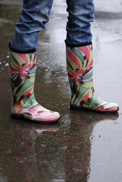 Woman\'s Legs Wearing Rainboots in Puddle