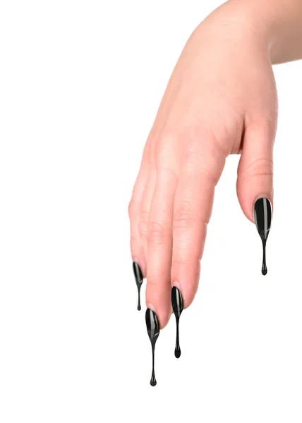 Female nails painted black. Nail polish dripping on the nail