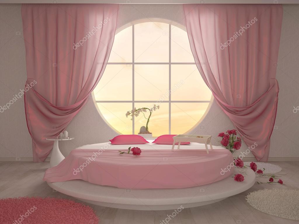 Sovrum med en cirkulär fönster och en rund säng i rosa ...