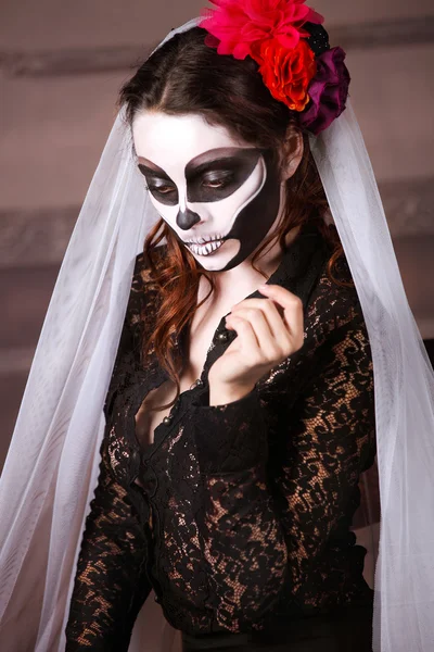 Beautiful woman painted as skeleton