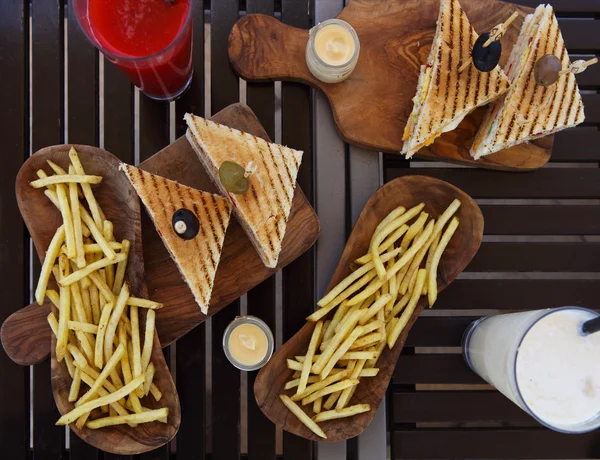 Chicken club sandwiches and french fries on the table