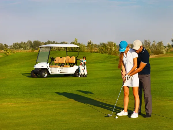 Sportive happy family playing golf