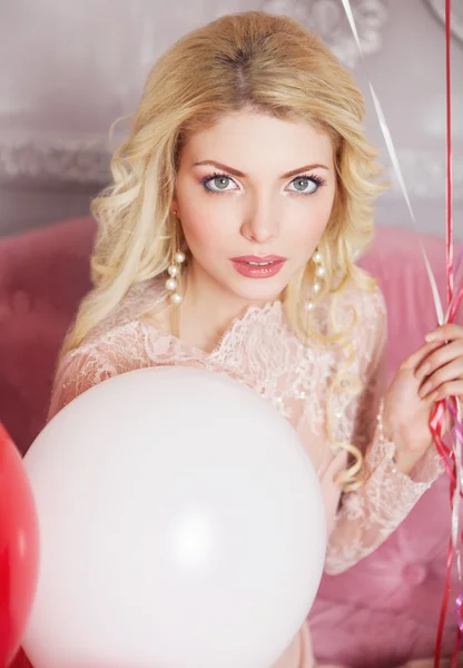 Romantic portrait of a beautiful girl with balloons