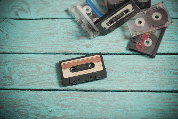 Audio tapes on blue wooden background