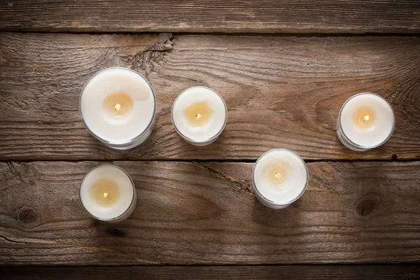 Scented candles on old wooden background