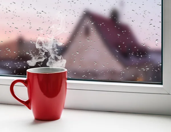 Cup of coffee on windowsill