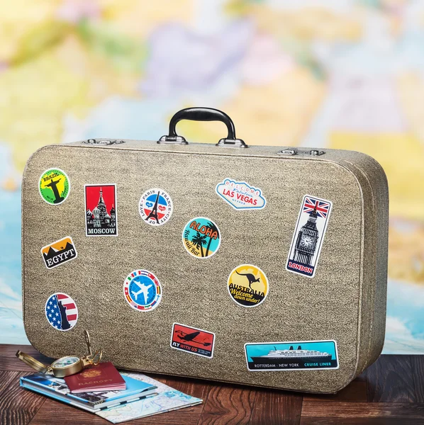 Retro suitcase with stickers on the floor