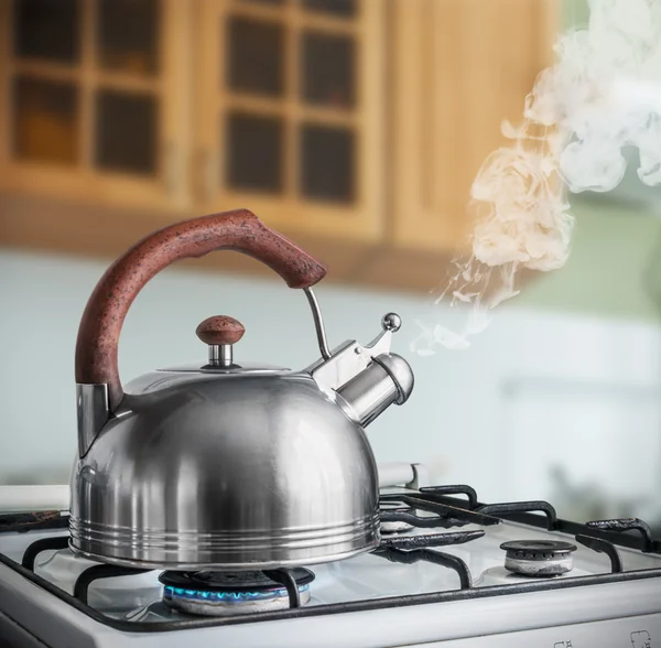 Kettle boiling on gas stove