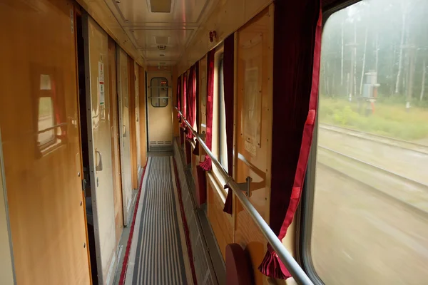 Interior of Ukrainian old railway carriage corridor on the move