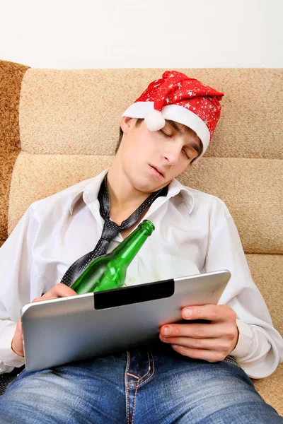 Teenager sleeping with a Beer and Tablet