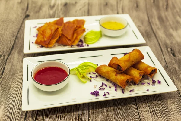 Set appetizing Chinese fried pancakes with vegetables with sweet-sour sauce.