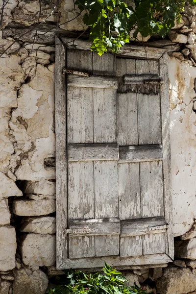 Old door in the stone walls of the village houses. Excellent background.