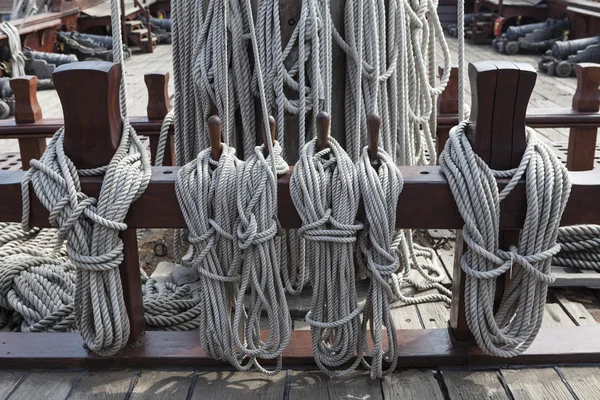 Older intricate marine ropes closeup on a ship deck.