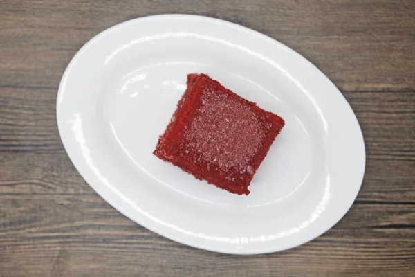 Red Velvet, fresh delicious diet cake  at Dukan Diet on a porcelain plate on a wooden background.