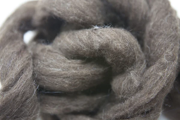 Arsenic gray piece of Australian sheep wool Merino breed close-up on a white background