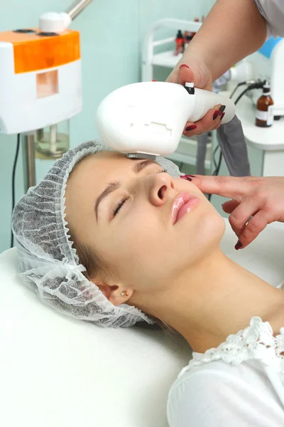 Woman having facial hair removal laser.