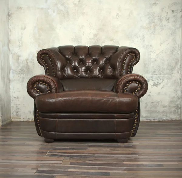 Old vintage brown leather chair in room