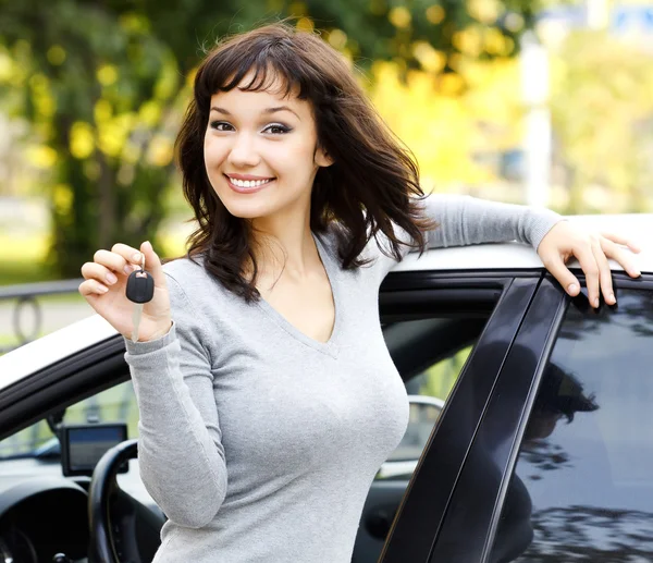 Pretty girl showing the car key