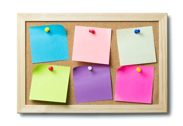 Blank post it notes on a cork notice board