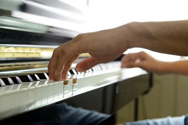 Musician hands on piano