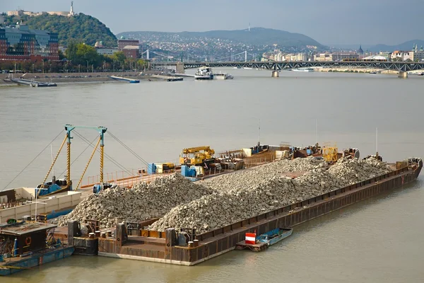 Barges with construction material