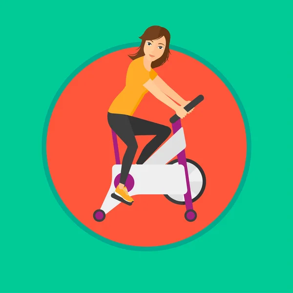 Woman riding stationary bicycle.