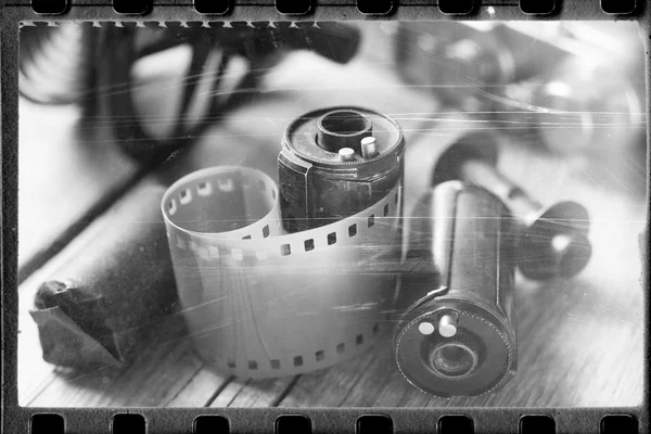 Old film stylized photo of rolled up film, cassette and retro ca