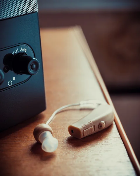 Hearing aid and music speaker on desk