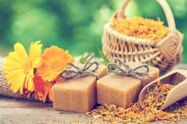 Bars of homemade soaps and calendula flowers. Vintage stylized p