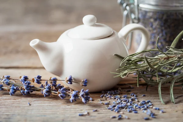 Teapot of healthy herbal tea and dry lavender flowers